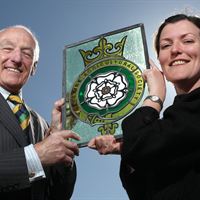 Michael Bannister, a former President of the Yorkshire Agricultural Society with his gift to the Society of a stained glass panel, and the panel’s designer, Julia Spall.