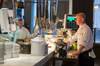Rob Mitchell beside a QSR ConnectSmart Kitchen screen, supplied by CST, at Drake & Morgan's venue, The Anthologist