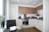 The stylish open-plan kitchen area in the new showhome at Victory Pier by Berkeley