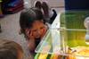 Four-year-old Lily Smallwood gets an up-close look at newly hatched chicks at The Old Station Nursery's Lincoln marina setting