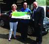 Lucky motorist Christine Jackson collects funds from Forté to spend on fuel costs