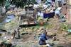 People washing adjacent to run-off from Dump Site