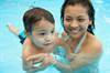 Hispanic mom baby swim