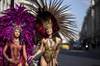 In Regent Street carnival dancers Jennice Crystal Price and Lolo Page from Trinidad and Tobago wearing costumes by Bacchanalia warm up for InsureandGo The World on Regent Street