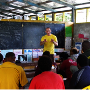 A Volunteer Minister of the South Pacific Goodwill Tour covers information to improve teacher and student performance at a workshop at Visale Primary School.