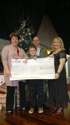 Harry Jewitt receives a cheque for £500 from Selby Music Centre for Great Ormond Street