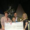 Harry Jewitt receives a cheque for £500 from Selby Music Centre for Great Ormond Street