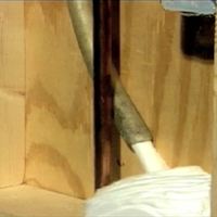 Insulation foam is injected into an existing wall cavity via a tube