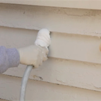 USA Premium Foam insulation is injected into the walls of an existing home from the outside