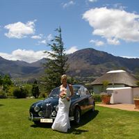 Bride with vintage car at Mont Rochelle