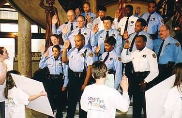 Scientologist Julie Brinker (far left) at 16, swearing in the  St. Louis Narcotics Division as Drug-Free Marshals