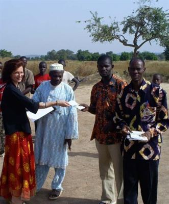 Scientologist Catherine Remise distributes copies of the nonreligious, common-sense moral code  The Way to Happiness in the village of Diokeli, Mali.