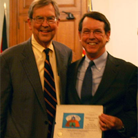 Pasadena Mayor Bill Bogaard (left) and Tim Bowles, Human Rights Director of the Church of Scientology Pasadena and Director of International Development of Youth for Human Rights International, in Pasadena City Council chambers.