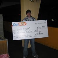 Winner Josh Neifert holding an oversized $10,000 check.