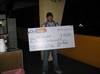 Winner Josh Neifert holding an oversized $10,000 check.