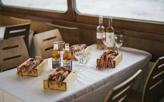 A table with bottles of wine and seafood
AI-generated content may be incorrect.