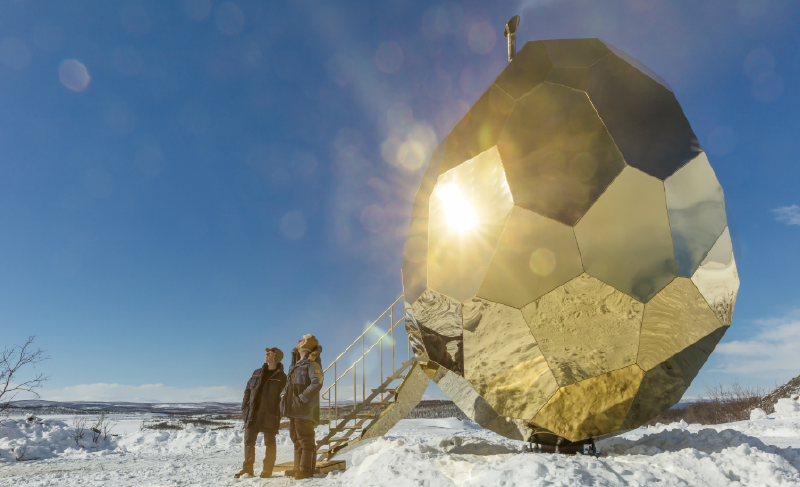A group of people standing next to a large gold ball

AI-generated content may be incorrect.