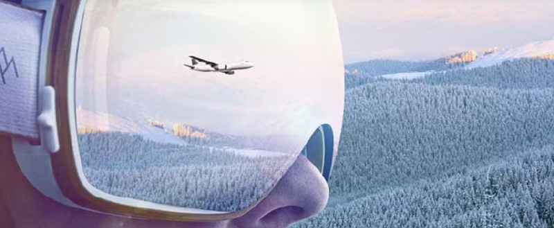 A person wearing sunglasses with a plane flying over the mountains
AI-generated content may be incorrect.