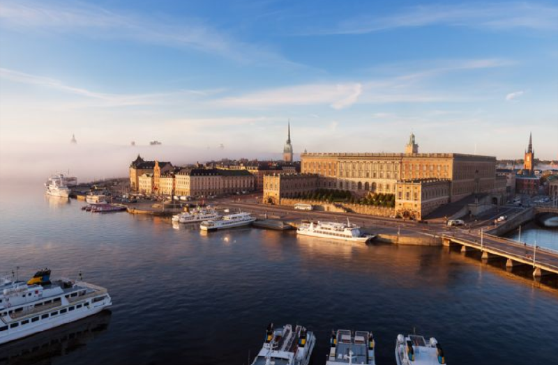 A large building next to a body of water
AI-generated content may be incorrect.