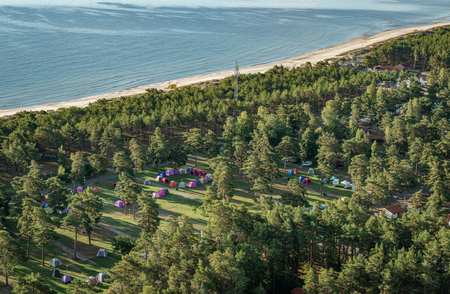 A group of tents in a forest by a beach

AI-generated content may be incorrect.