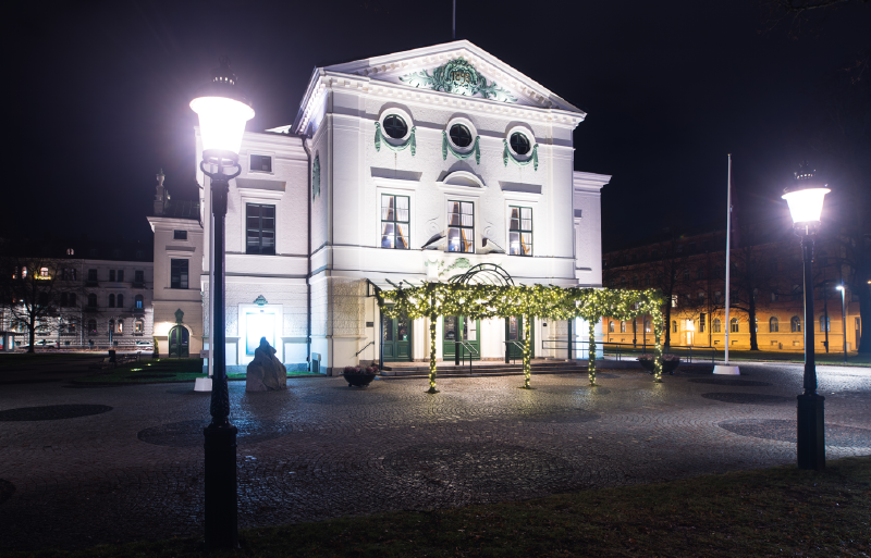 A white building with lights on the outside
AI-generated content may be incorrect.