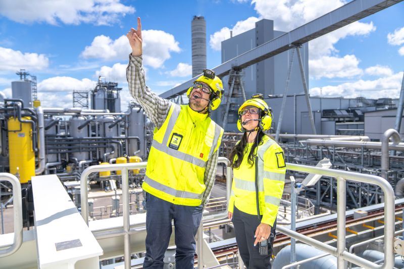 A person and person wearing safety vests and helmetsAI-generated content may be incorrect.